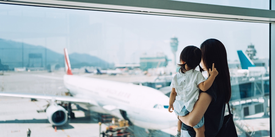 A mother with her daughter watching planes at airport
